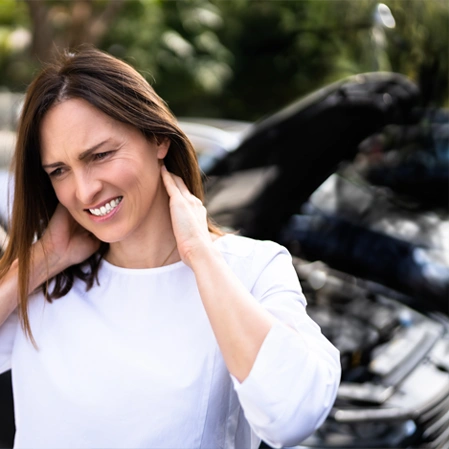 Person standing near a car with the hood open