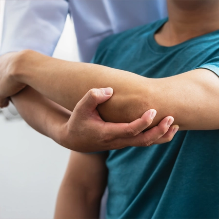 A personal receiving physical therapy on their arm.